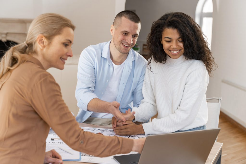 female-realtor-showing-new-house-smiley-couple-laptop
