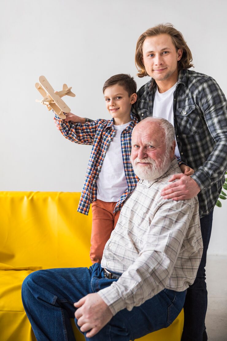 multigenerational-men-hugging-looking-camera