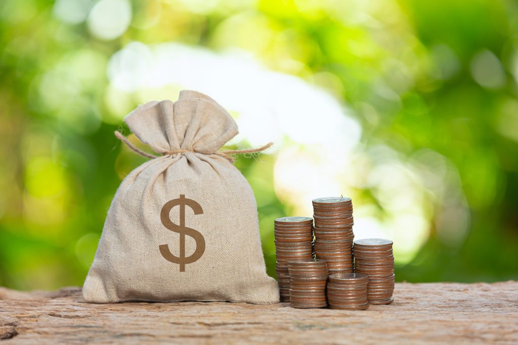 World Habitat Day,close up picture of a pile of coins and a sag